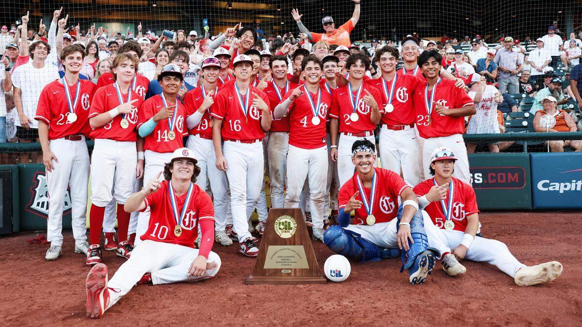 Grapevine baseball players stand in front of their fans with the championship trophy after defeating Kingwood Park 9-5 in the Class 5A Division II state championship game June 6, 2025, at Dell Diamond in Round Rock.