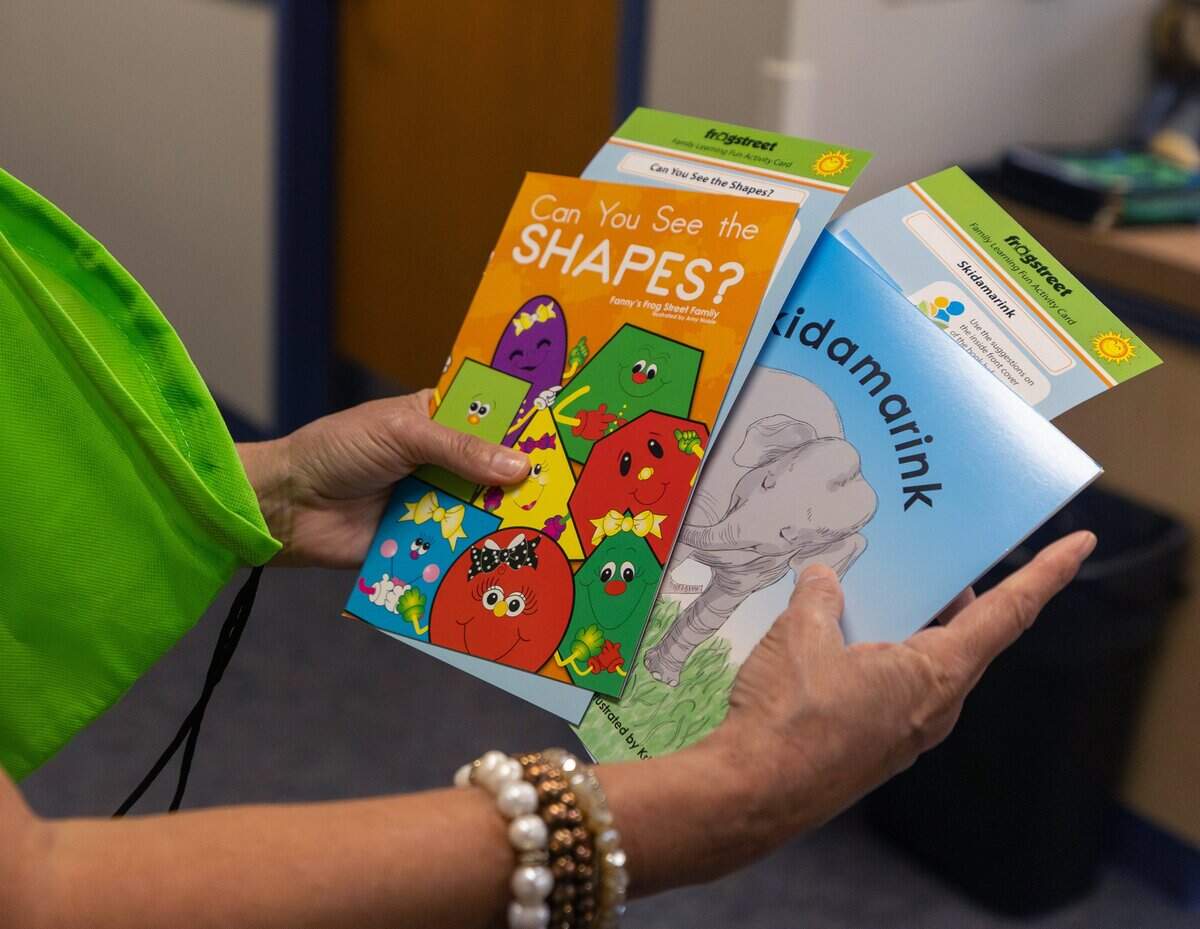 June Ritchlin, executive director of educational leadership shows the contents of a bag that is given to every Pre-K student during a pre-K prep program at Castleberry Elementary School in Fort Worth on June 29, 2026. At the start of every week students receive a different bag containing that week's learning materials.