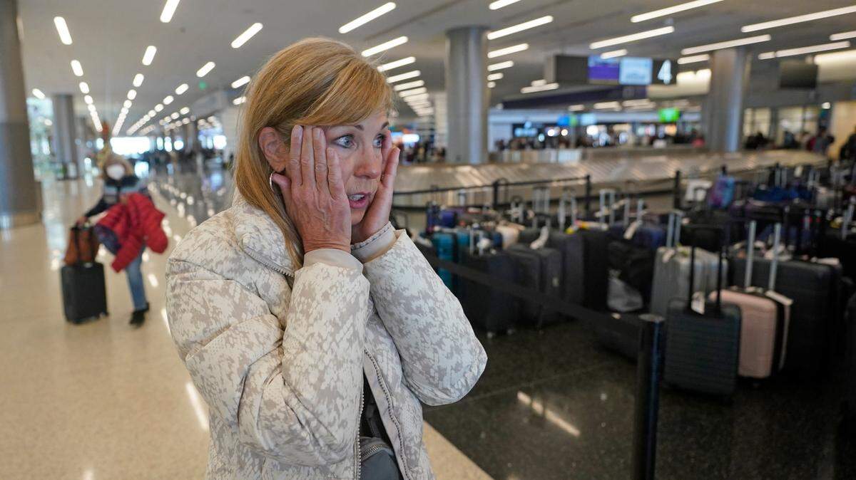 Chicago traveler Shana Schifer reacts after receiving her bags that had been lost since Christmas Day at the Southwest Airlines unclaimed baggage area at Salt Lake City International Airport on Thursday, Dec. 29, 2022. Southwest Airlines said it expects to return to normal operations Friday after slashing about two-thirds of its schedule in recent days, including canceling another 2,350 flights Thursday. (AP Photo/Rick Bowmer)