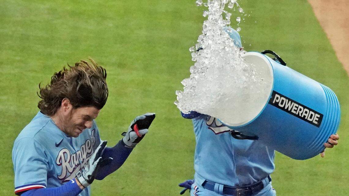 Jonah Heim is greeted by teammates at home plate after his walk-off home run in the ninth inning of Sunday’s 4-3 win over the Seattle Mariners. “If I keep doing this it’s going to be a pretty good year,” Heim said.