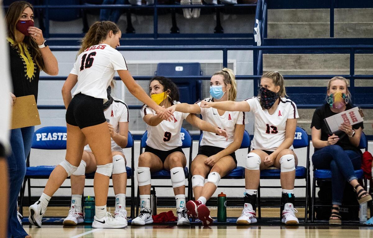 Argyle players bump fists with each other while wearing masks during the season opening tournament Tuesday, Aug. 11, 2020, in Peaster High School.