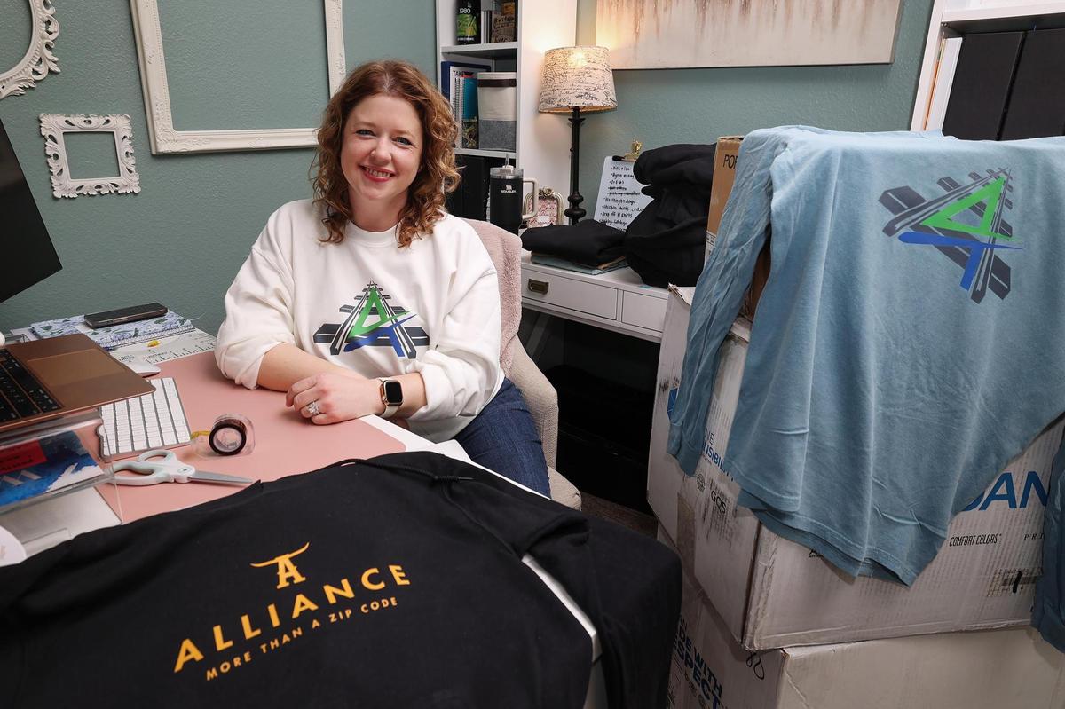 Michelle Gibson, a graphic designer, created Alliance branded merchandise after hearing about the proposed plan to split the Keller school district. Gibson said she was inspired by the satirical Alliance ISD Facebook page created in response to the plan. All money raised will go towards a fund to help children in the Keller school district who could not afford their lunches.