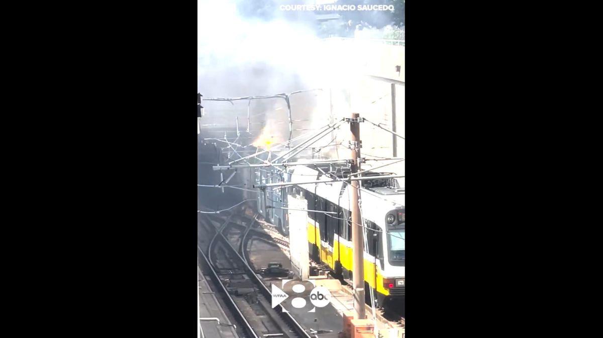 Flames shoot out of a DART train car near North Central Expressway and Ross Avenue on Wednesday afternoon.