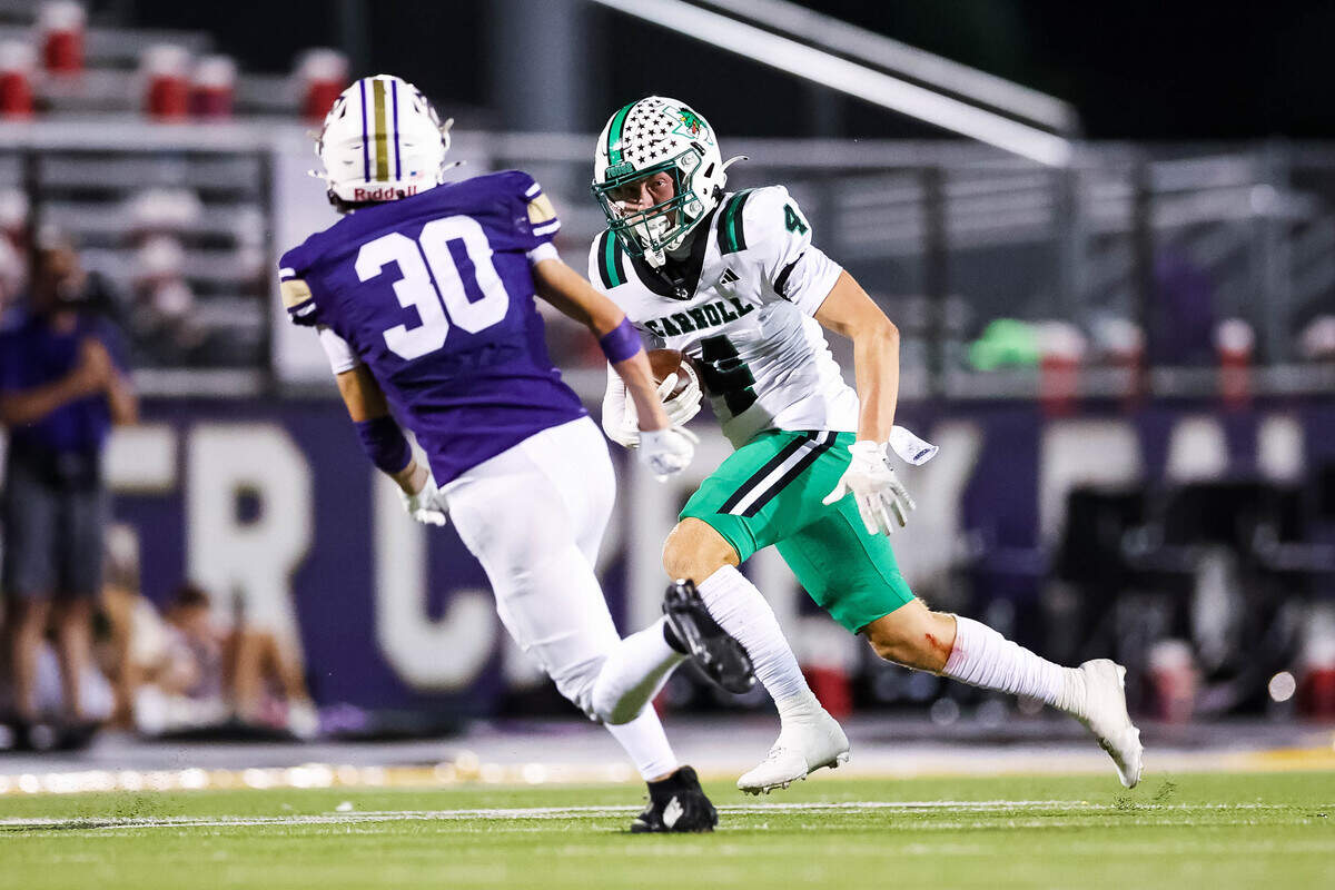 Southlake Carroll wide receiver Luc Jacquemard (4) runs with the ball after making a catch defended by Keller Timber Creek’s Griffin Schubert (30) during a district matchup on Thursday, September 25, 2025 at Keller ISD Stadium in Keller, Texas.