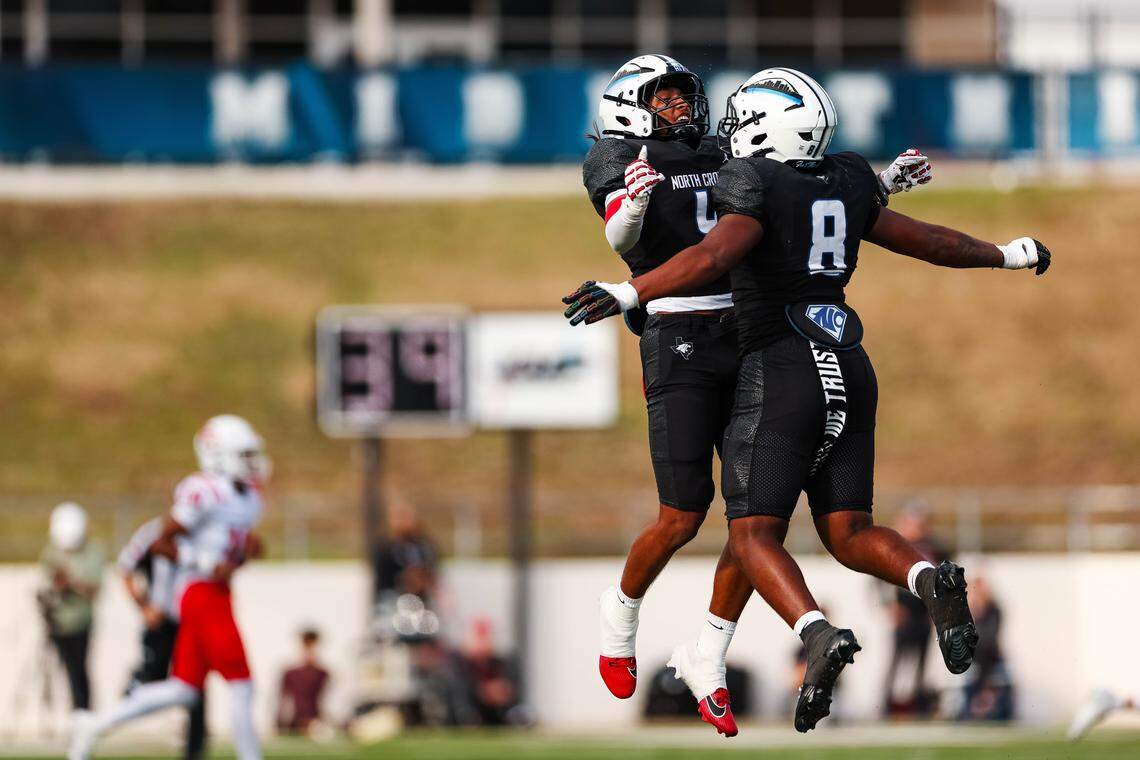 North Crowley defensive back Jerry Outhouse (4) leaps in the air to chest-bump teammate DeMorey Beasley (8) in a Class 6A Division I regional playoff Saturday, Nov. 29, 2025, at Midlothian ISD Stadium in Midlothian.