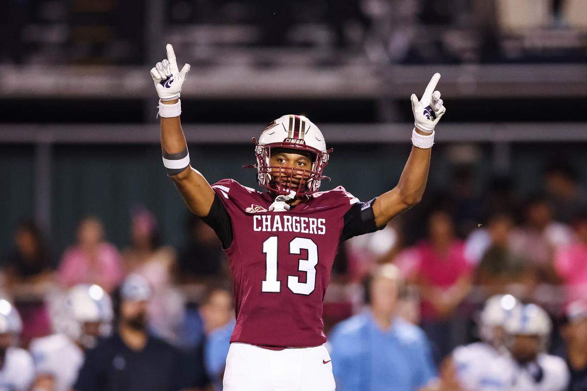 Keller Central player Ja'Mari McGee points his hands in the air in celebration after making a play during a district game between Keller Central and L.D. Bell at Keller ISD Stadium in Keller, Texas on October 16, 2025.