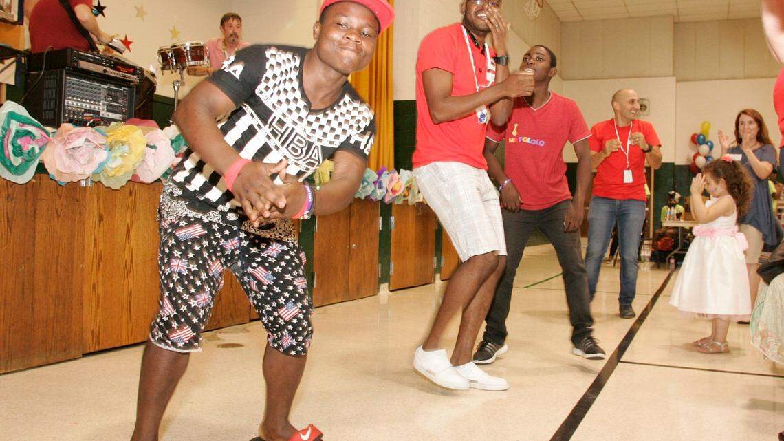 Mika Abanda and Marvin Jimu dance during a World Refugee Day celebration at Refugee Services of Texas in this file photo.