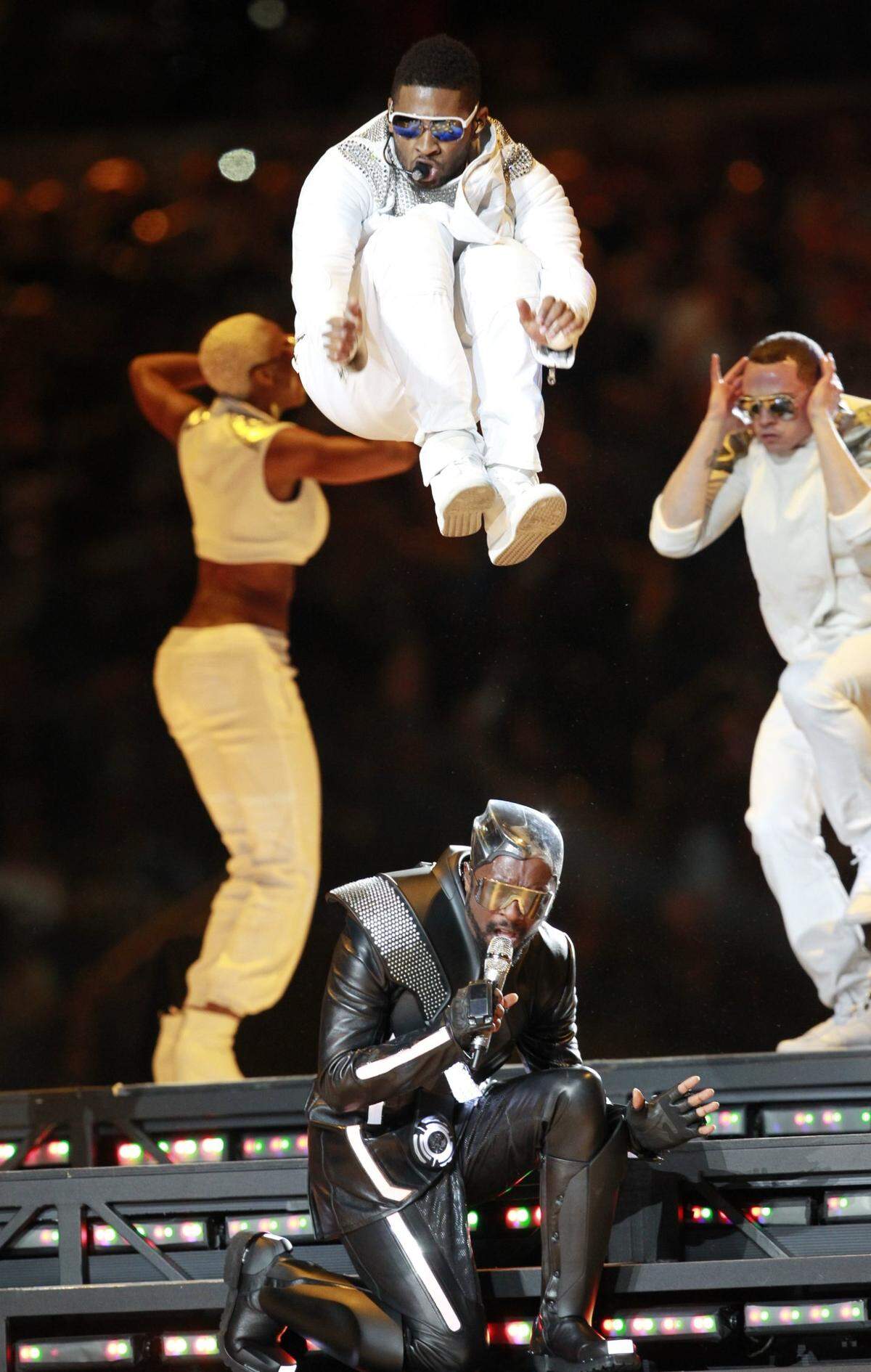 Usher jumps over will.i.am during Super Bowl XLV in Cowboys Stadium in Arlington, Texas, Sunday, Feb. 6, 2011.  Arlington,Texas, Sunday, Feb. 6,  2011. (Star-Telegram/Ron Jenkins)