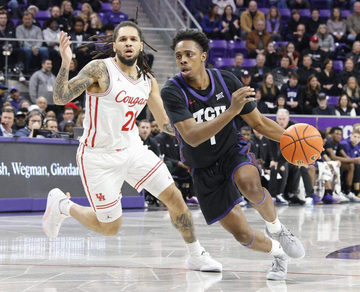 TCU guard Jayden Pierre (1) drives against Houston guard Emanuel Sharp (21) during the first half of a NCAA basketball game between the University of Houston and TCU at Schollmaier Arena in Fort Worth, Texas, Wednesday Jan. 26, 2026