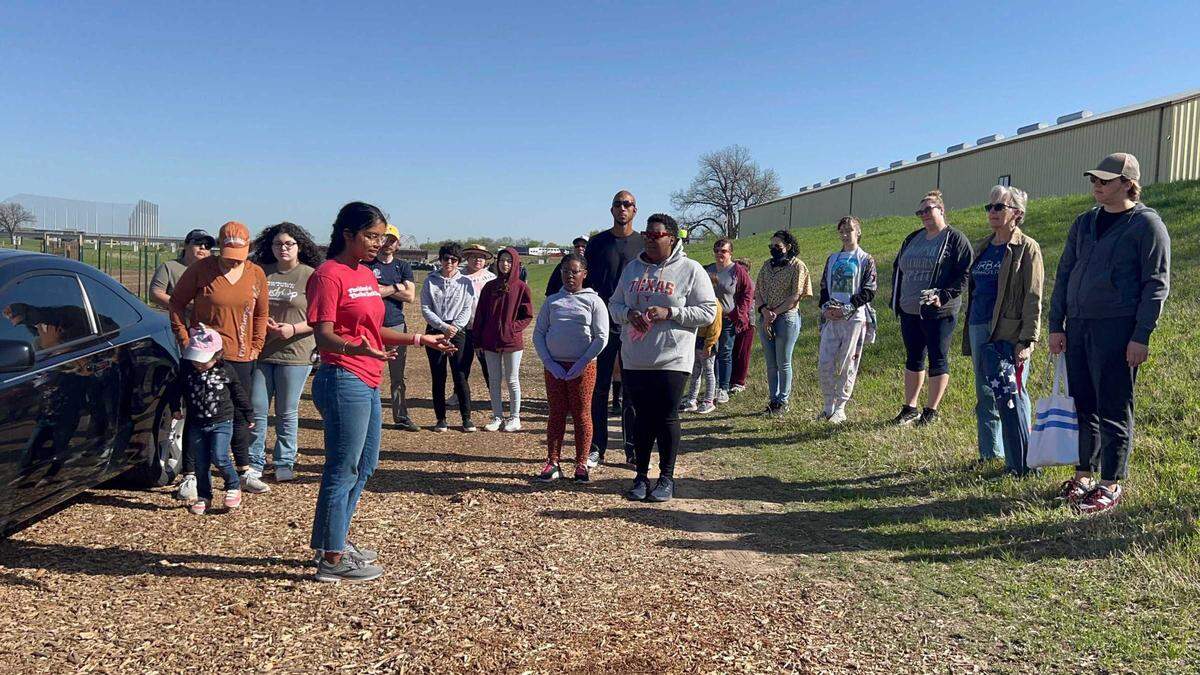 Maitri Kovuru speaks to a crowd on Opal’s Farm.