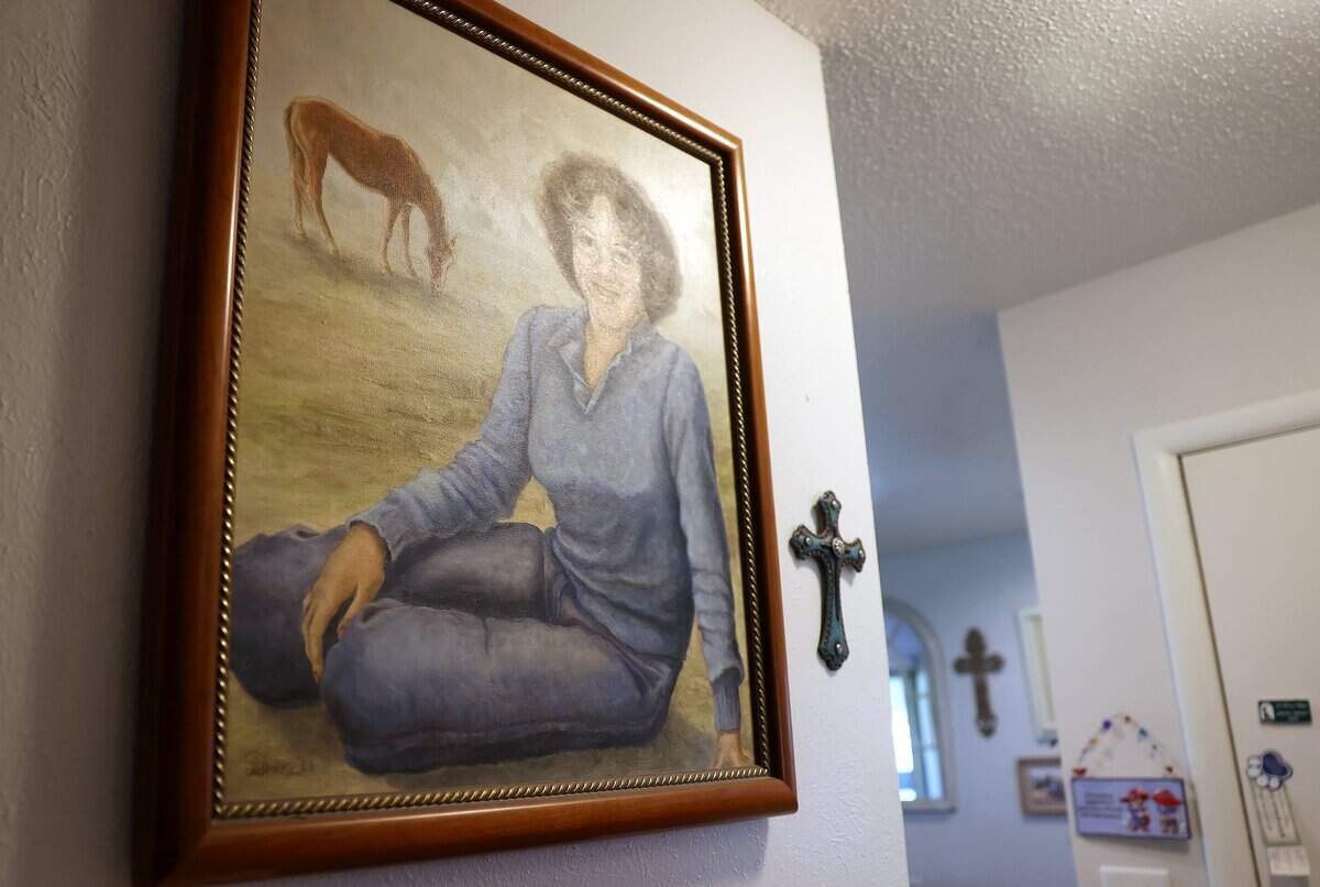 Johnetta Smith keeps a wall dedicated to her daughter, Shelly Colliflower, in her Crowley home. Colliflower was murdered in 1983. The case remains unsolved.