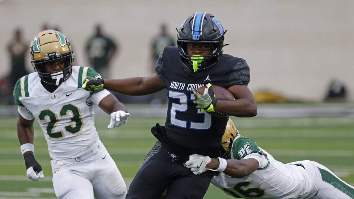 North Crowley running back Kiante Ingram (23) brings the ball up field ahead of DeSoto linebacker Terrance McKnight (23) during the first half of a UIL football game between DeSoto and North Crowley at Crowley ISD Multi-Purpose Stadium in Fort Worth, Texas, Friday, Sept. 05, 2025.