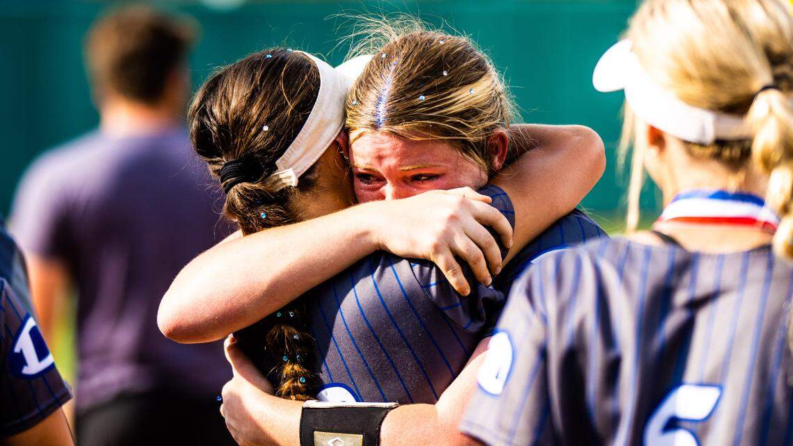Decatur softball players console one another after the Eagles lost to Liberty, 9-1, in the Class 4A state semifinals on Thursday, June 1, 2023 at McCombs Field in Austin, TX.