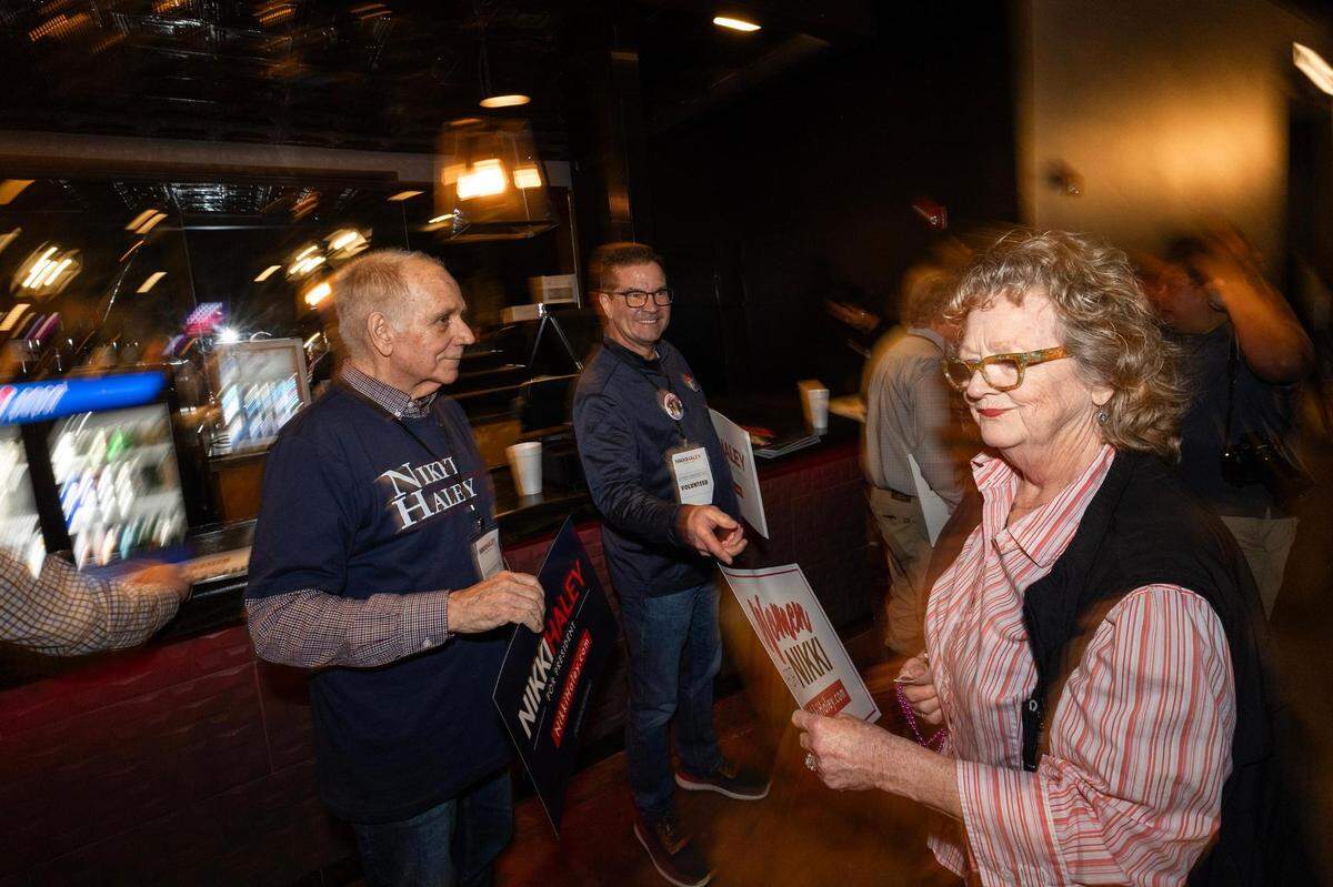 Campaign volunteer Frank Allen hand out campaign signs to supporters of Republican presidential candidate Nikki Haley during her presidential campaign rally at the Southside Music Hall in Dallas on Thursday, Feb. 15, 2024.