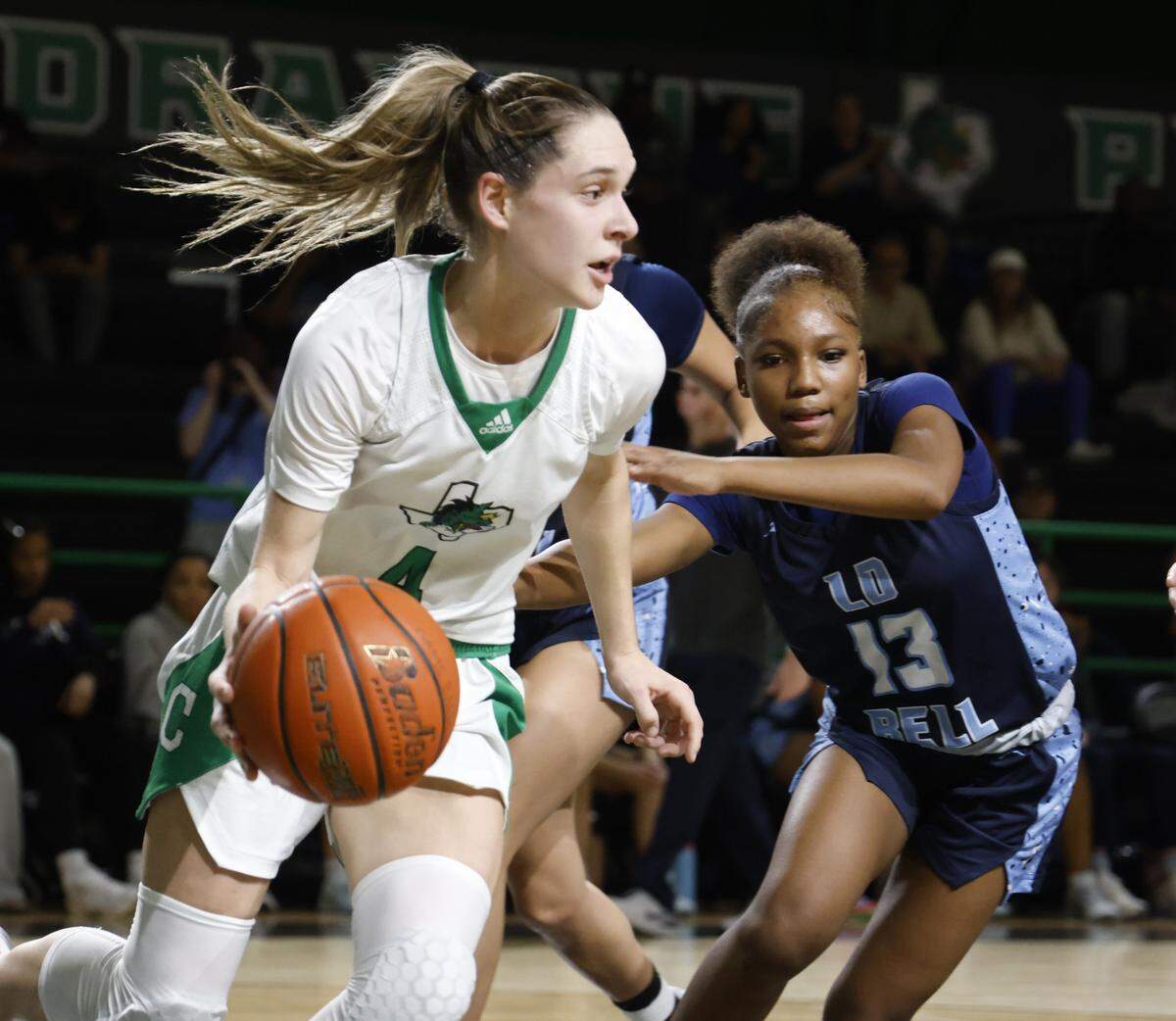 Southlake guard Mattie Renda (4) grabs a defensive rebound  defended by L.D. Bell guard Jenai Griffin (13) during the second half of a UIL girls basketball game between L.D. Bell and Southlake Carroll at Southlake Senior High School in Southlake, Texas, Tuesday Feb. 03, 2026