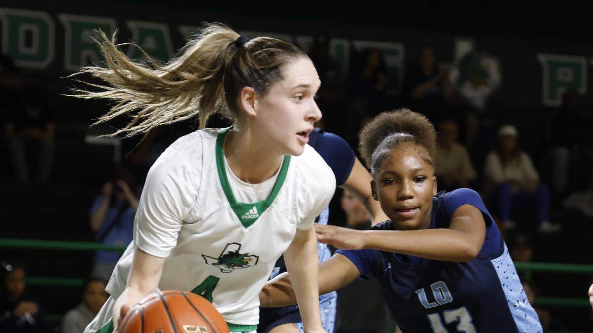 Southlake guard Mattie Renda (4) grabs a defensive rebound defended by L.D. Bell guard Jenai Griffin (13) during the second half of a UIL girls basketball game between L.D. Bell and Southlake Carroll at Southlake Senior High School in Southlake, Texas, Tuesday Feb. 03, 2026