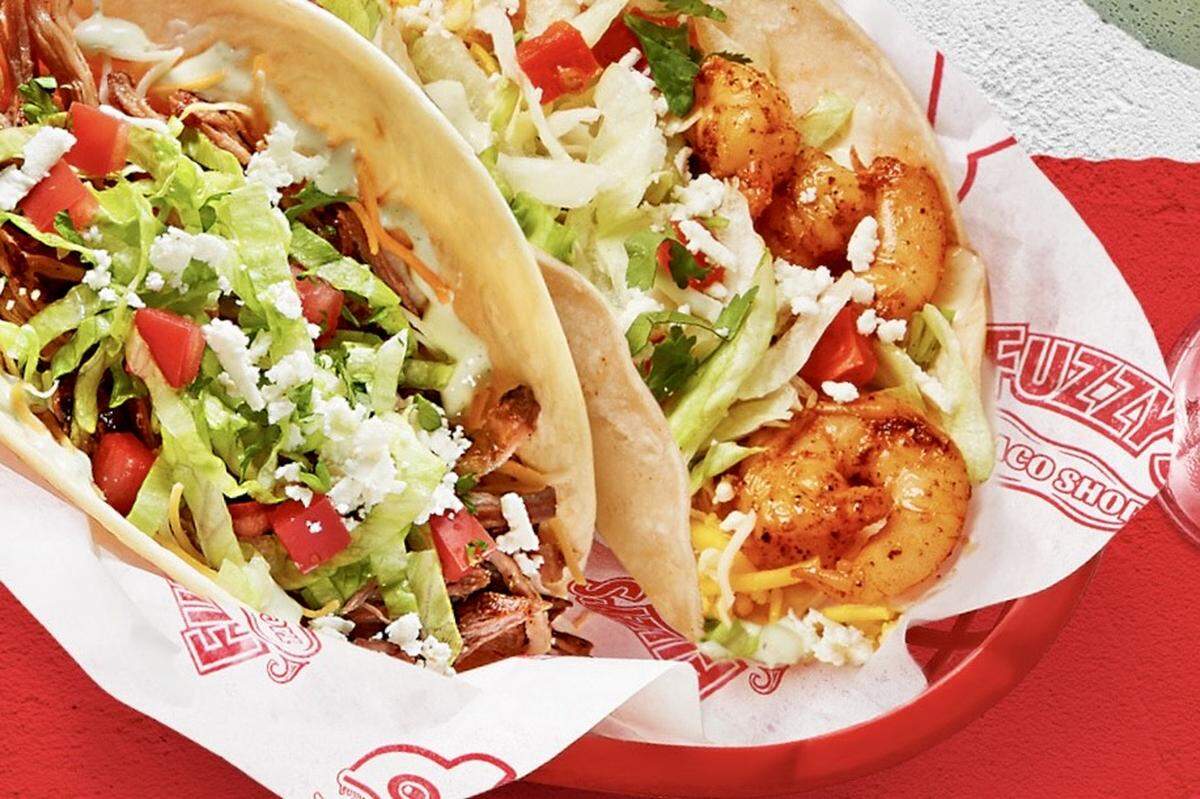 A shredded brisket taco and a grilled shrimp taco at Fuzzy’s Taco Shop.