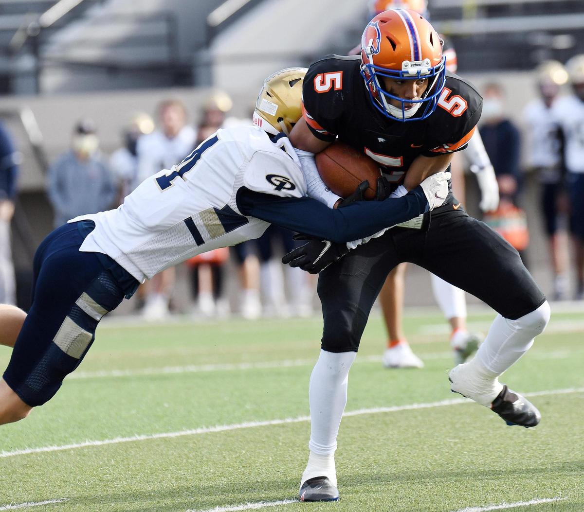 Grace Prep’s Kaden Lehew, left grabs Colleyville Covenant’s Isaiah Swift as the takes the ball to the one yard line and a first down in the first quarter of their TAPPS Division 3 Regional Round Play-off football game Saturday, December 5, 2020 at Pennington Field in Bedford, Texas. Special/Bob Haynes