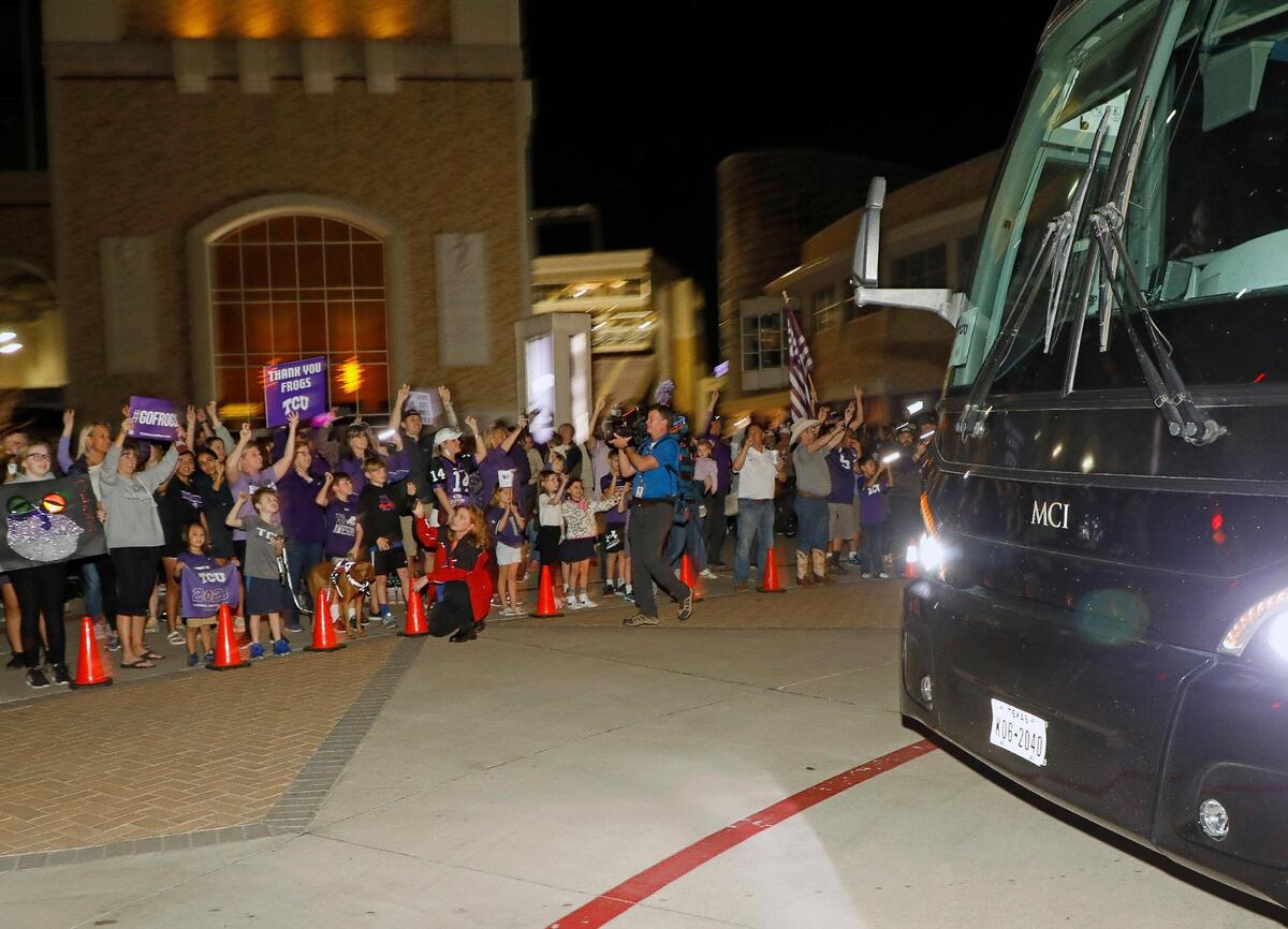 Fans cheer the TCU Horned Frogs as they return home after the CFP national championship football game to the TCU Campus in Fort Worth, Texas, Tuesday, Jan. 10, 2023.
