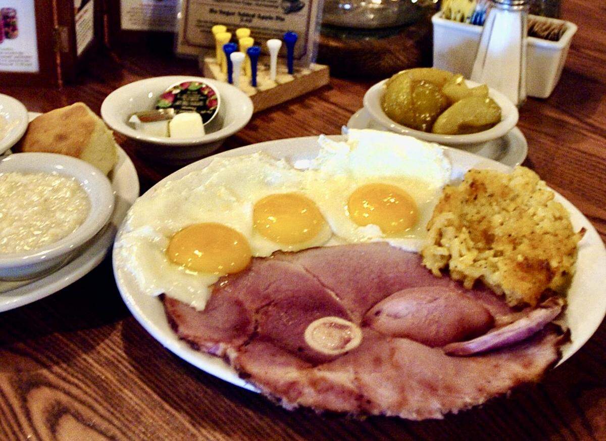 The “country boy” breakfast with eggs, the hash-brown casserole, grits, biscuits and gravy, and fried apples at a Cracker Barrel restaurant in Bradenton, Fla., on Aug. 26, 2004.