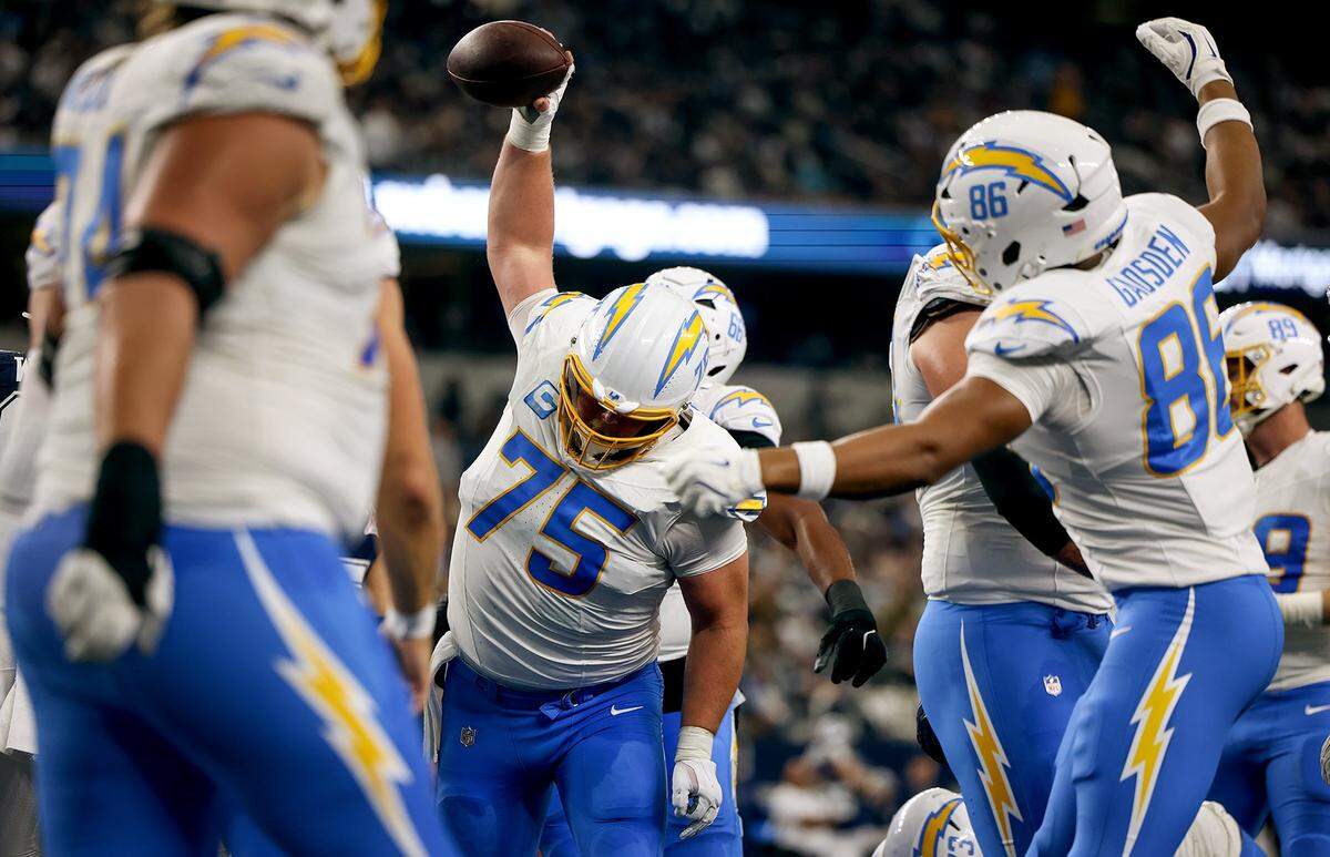 Los Angeles Chargers center Bradley Bozeman celebrates pushing into the end zone for a touchdown against the Dallas Cowboys by spiking the ball on Sunday, Dec. 21, 2025, at AT&T Stadium.