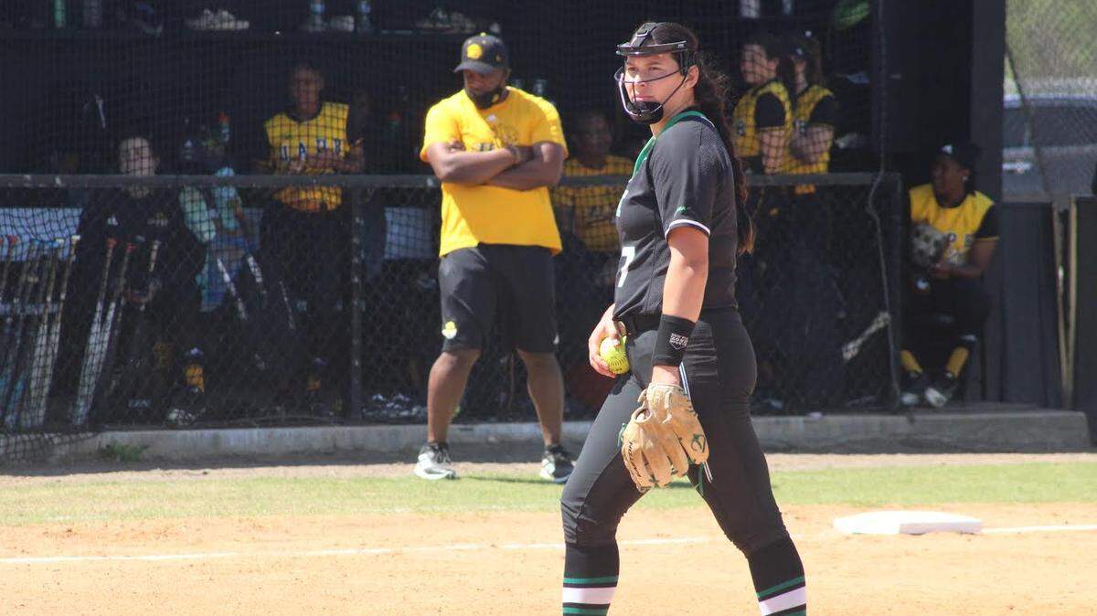 North Texas softball pitcher Hope Trautwein threw a perfect game against Arkansas Pine Bluff on Sunday as she struck out all 21 batters she faced. Pine Bluff coach Michael Bumpers (background) said she was great, but the home plate umpire was not.