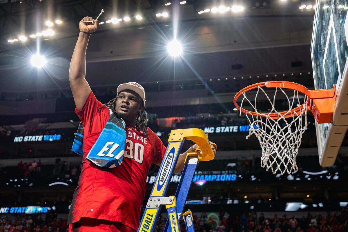 NC State forward DJ Burns Jr. (30) cuts the net to celebrate after winning their Elite 8 South Regional match up against the Duke Blue Devils and advance to the Final Four of the NCAA Division I Mens Basketball Tournament at American Airlines Center in Dallas on Sunday, March 31, 2024. NC State defeated Duke 76-64.