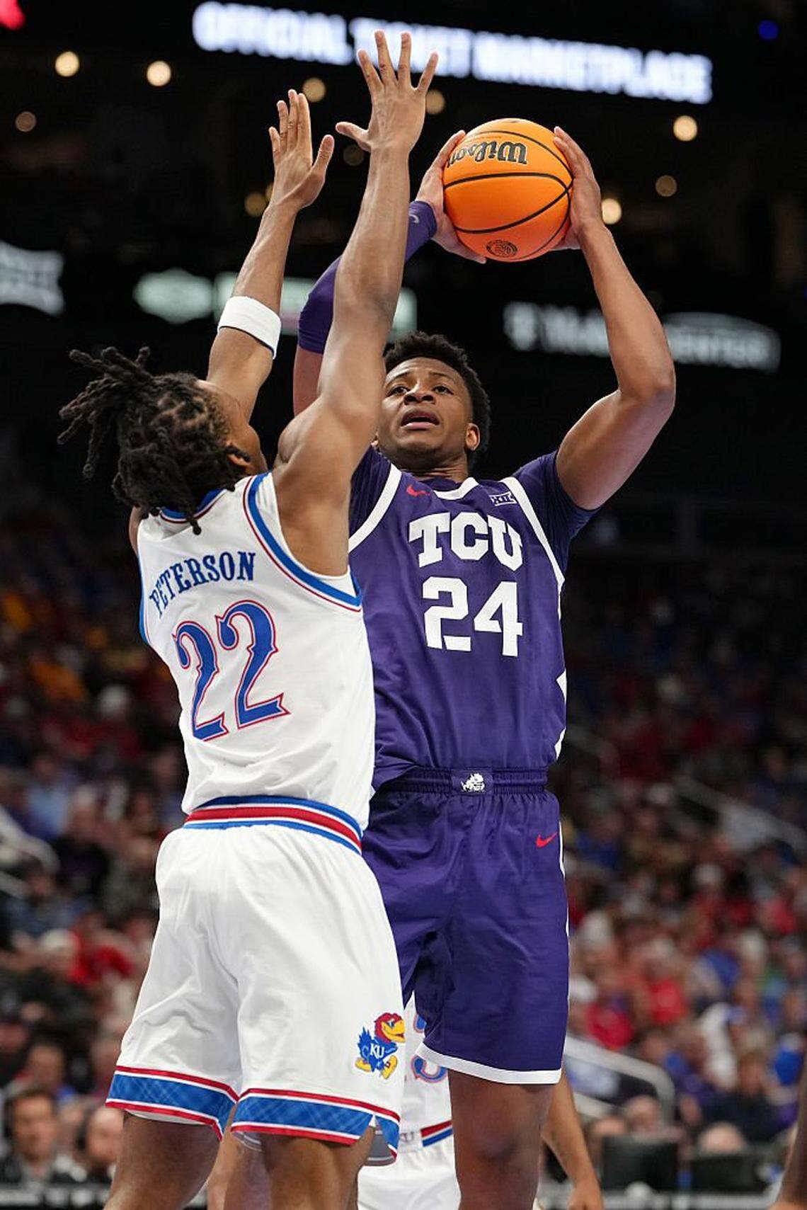 KANSAS CITY, MISSOURI - MARCH 12: Xavier Edmonds #24 of the TCU Horned Frogs shoots against Darryn Peterson #22 of the Kansas Jayhawks in the first half during the quarterfinals of the Big 12 Tournament at T-Mobile Center on March 12, 2026 in Kansas City, Missouri. (Photo by Ed Zurga/Getty Images)