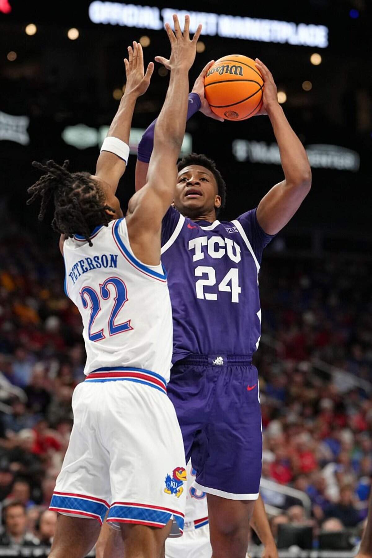 KANSAS CITY, MISSOURI - MARCH 12: Xavier Edmonds #24 of the TCU Horned Frogs shoots against Darryn Peterson #22 of the Kansas Jayhawks in the first half during the quarterfinals of the Big 12 Tournament at T-Mobile Center on March 12, 2026 in Kansas City, Missouri. (Photo by Ed Zurga/Getty Images)