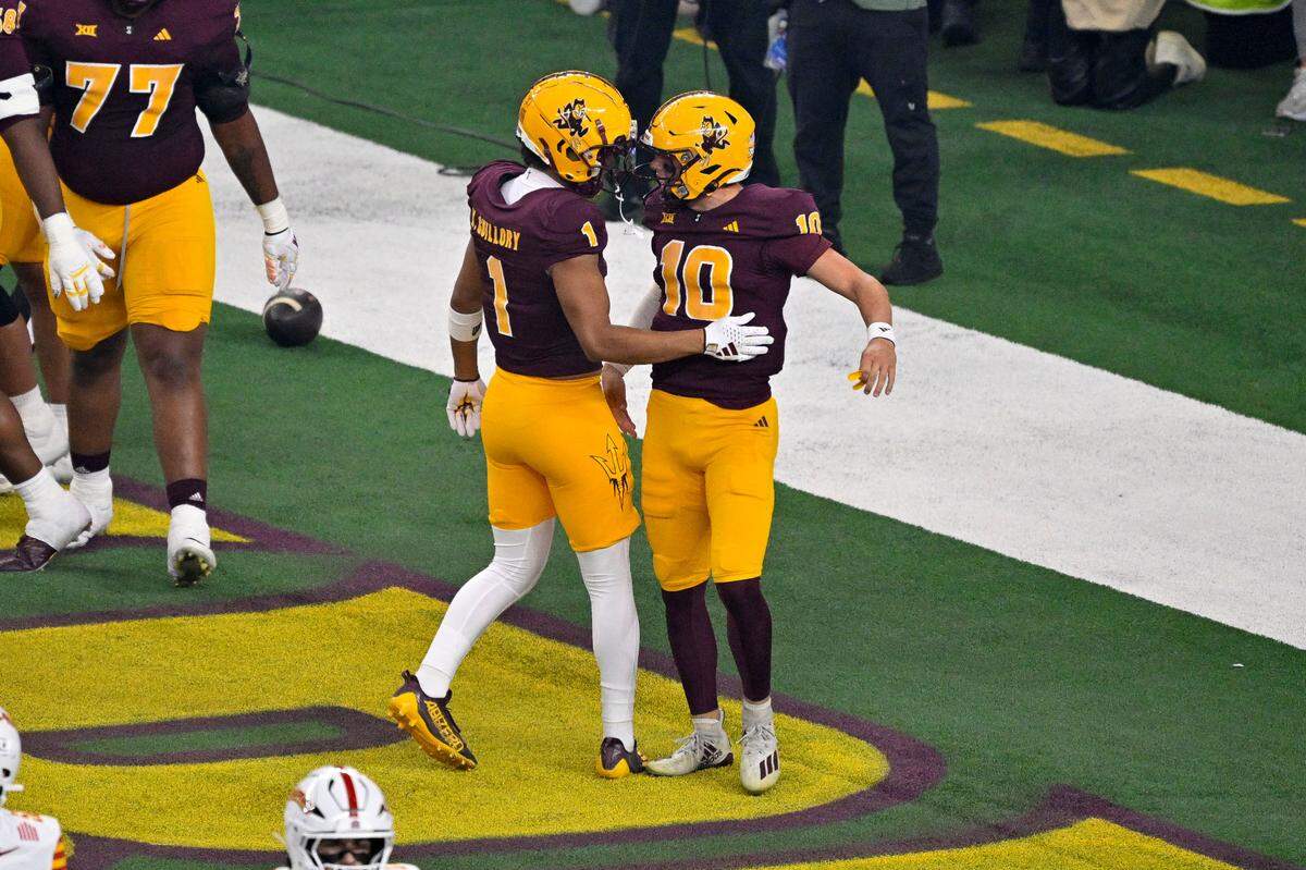 Arizona State Sun Devils quarterback Sam Leavitt (10) and wide receiver Xavier Guillory (1) celebrate after Leavitt scores a touchdown against the Iowa State Cyclones during the first half at AT&T Stadium.