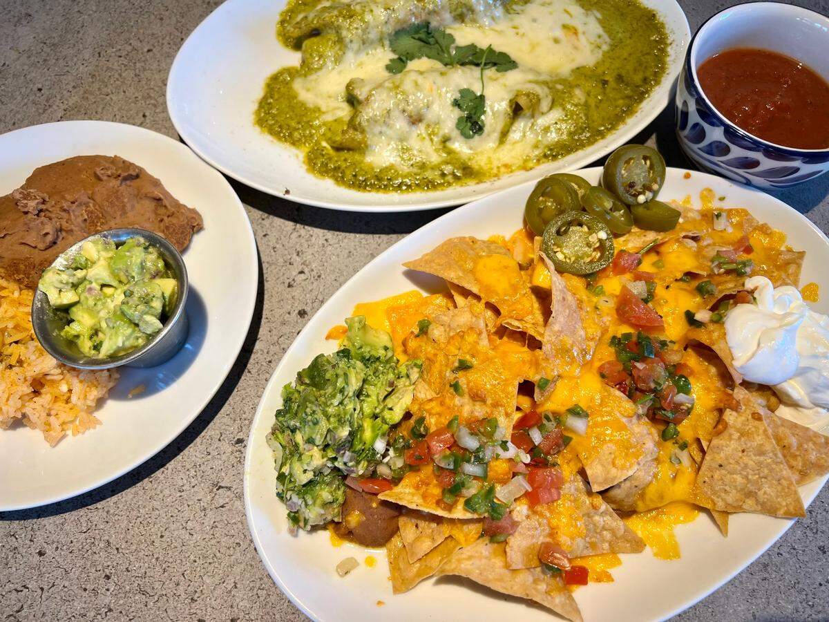 Nachos with fresh-made guacamole and chicken enchiladas poblano at Paloma Suerte.