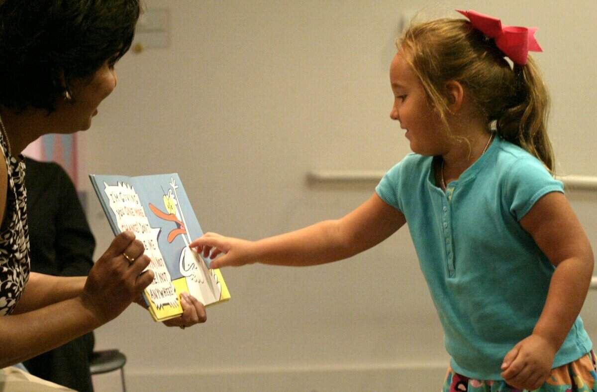 Children play a game of rubber ducky fishing at the Fort Worth Public Library in downtown Fort Worth in this June 2007 file photo.