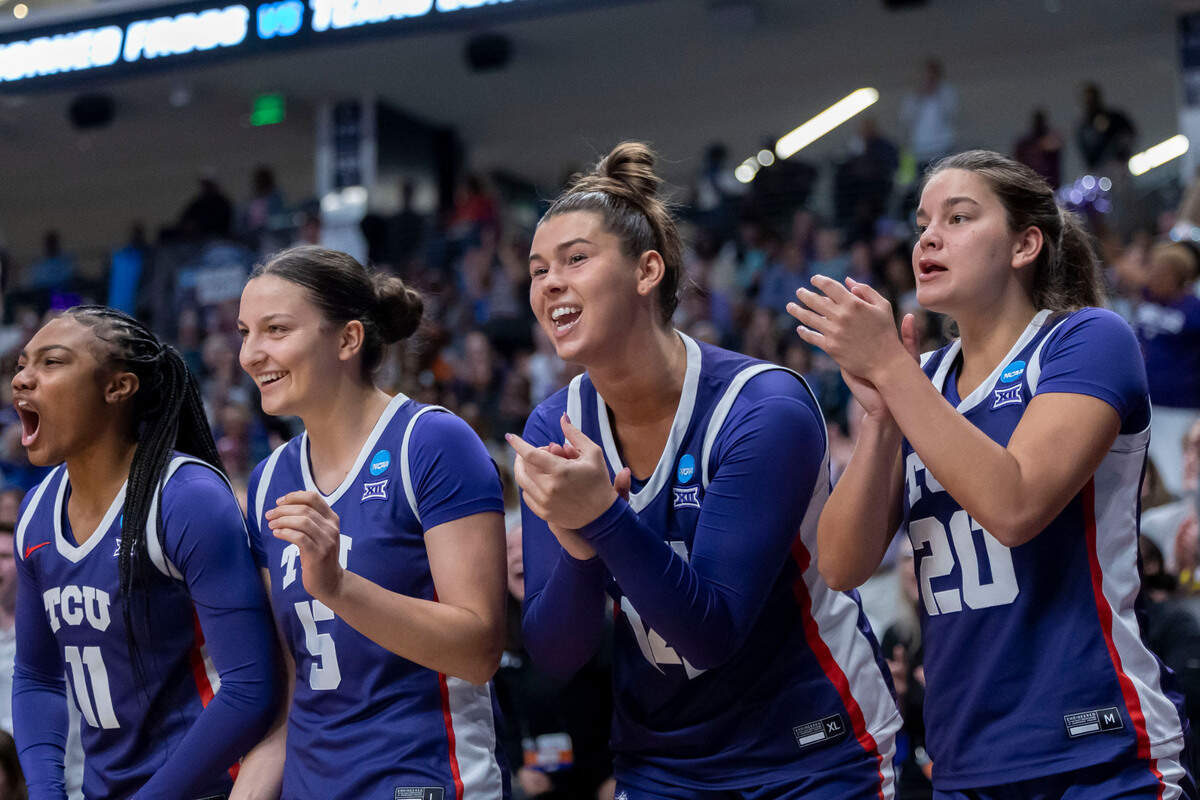 The TCU Horned Frogs bench cheer their team during the first half of an Elite 8 NCAA Tournament basketball game against the Texas Longhorns at Legacy Arena.