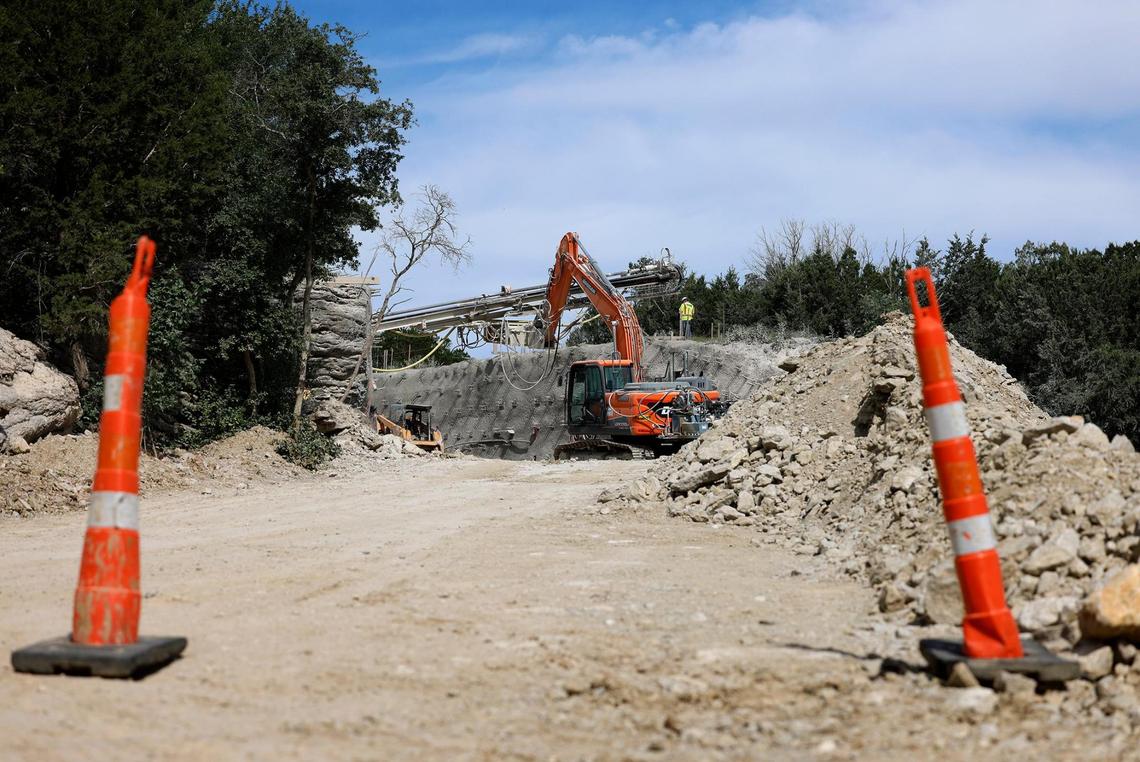 A construction crew works to install a retaining wall along the main road that will take visitors through Palo Pinto Mountains State Park on May 21.