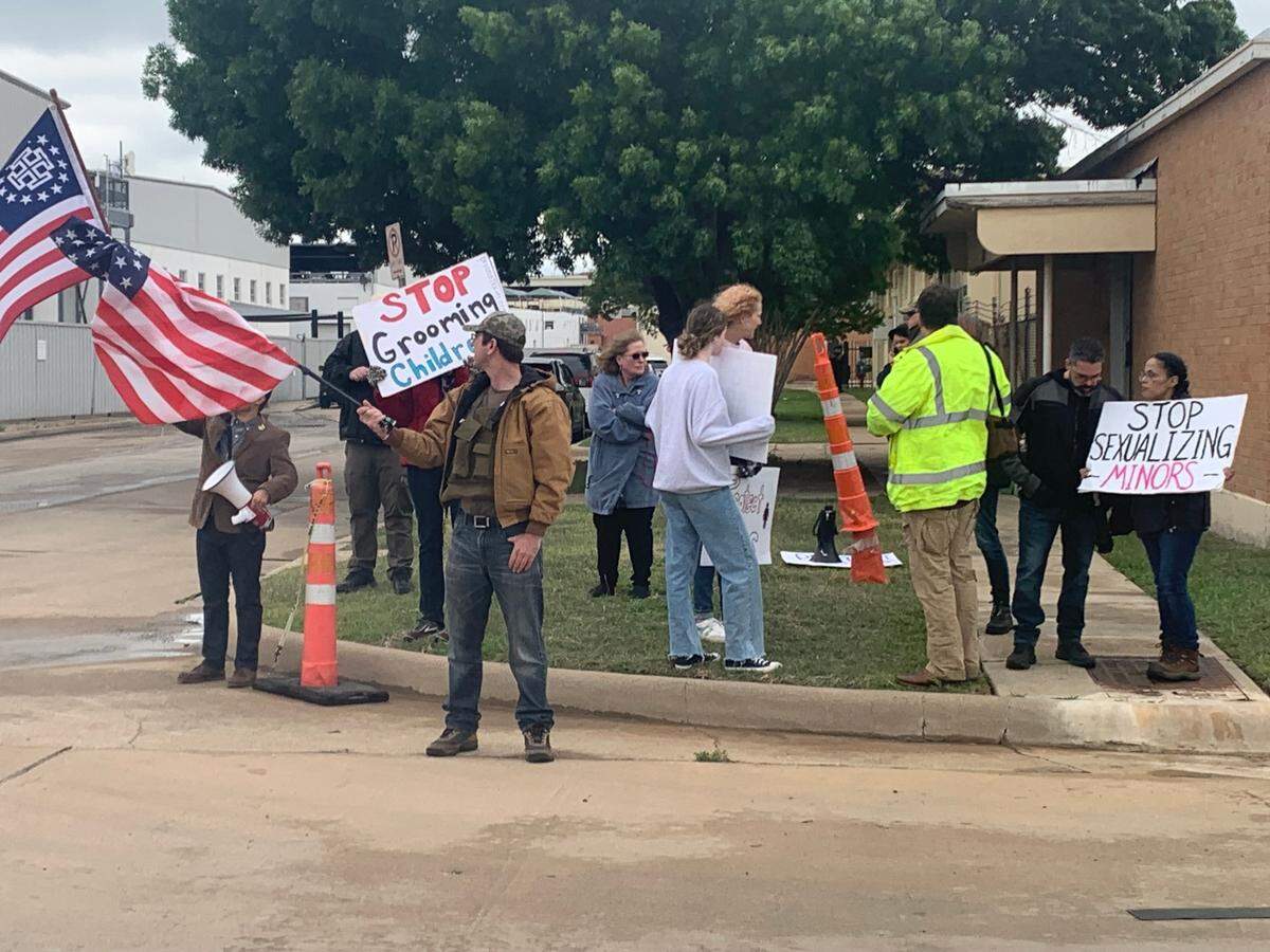 Members of anti-LGBT groups Protect Texas Kids and the New Columbia Movement gather across the street from a drag brunch Sunday to protest.