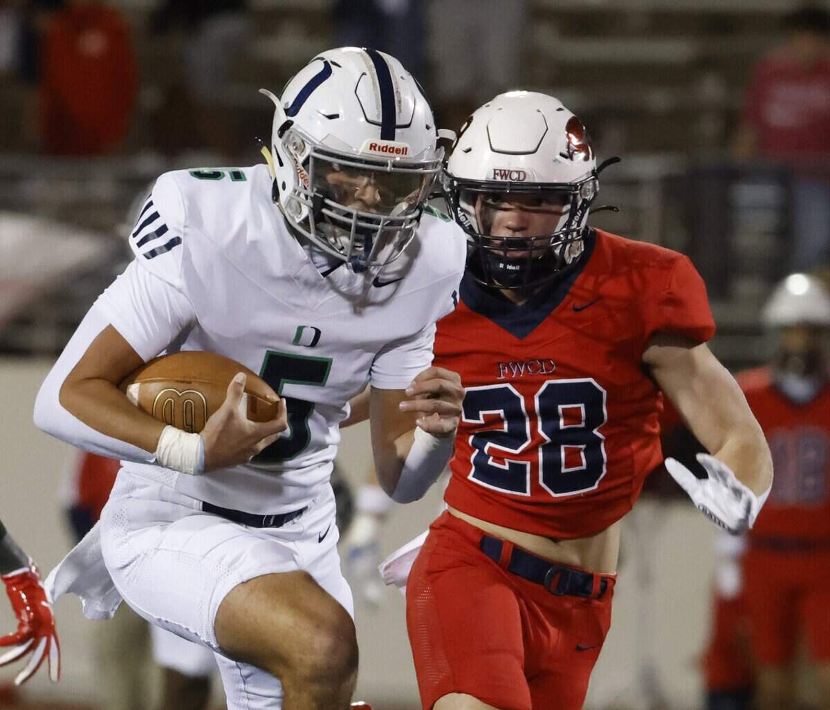 Oakridge quarterback Luke Dearman (5) runs past Country Day inside linebacker Thomas Bluntzer (28) during the first half of the SPC 2025 3A Football Championship football game between The Oakridge School and Fort Worth Country Day at Mavericks Stadium in Arlington, Texas, Saturday Nov. 08, 2025.