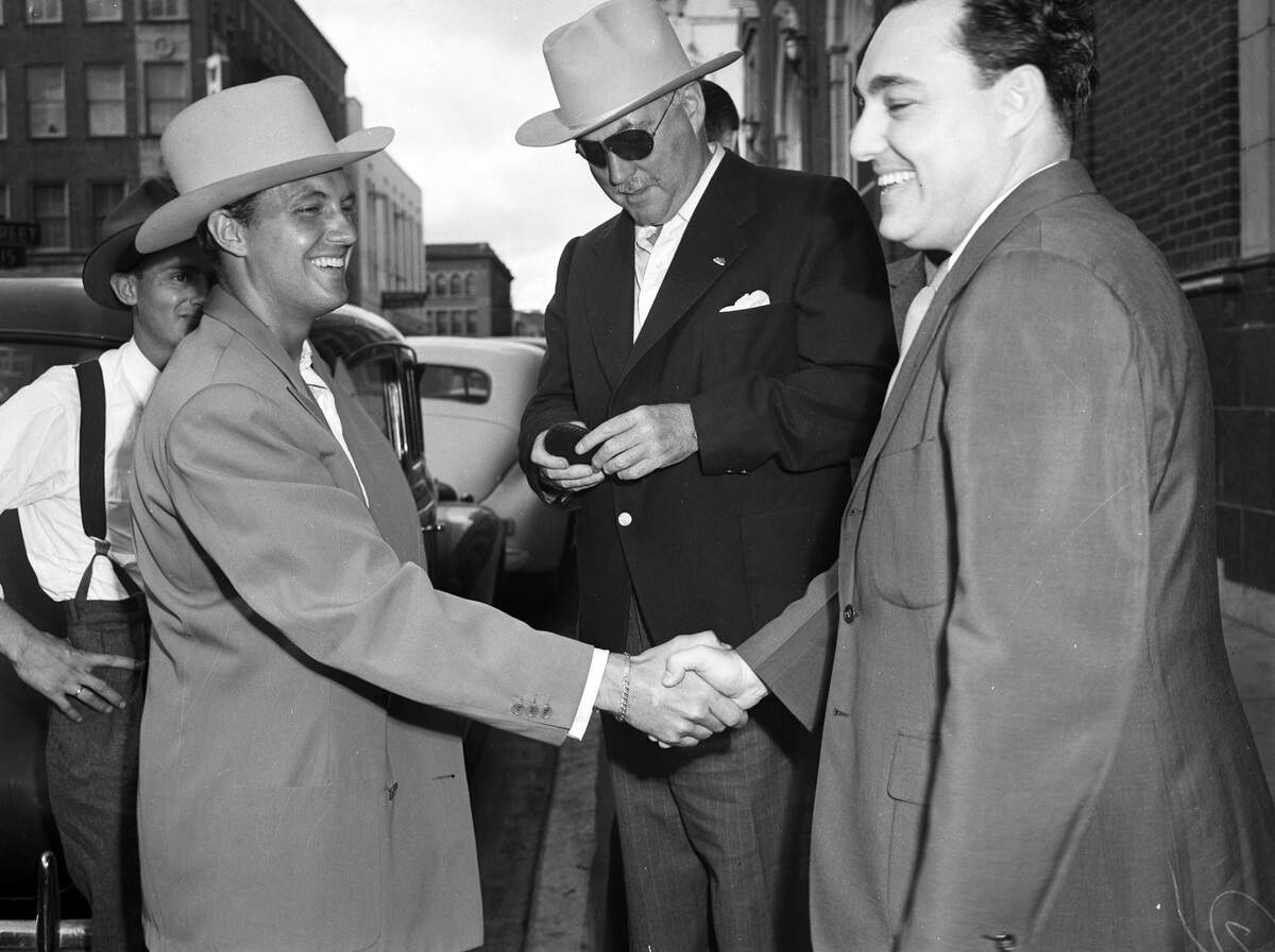 Sept. 18, 1942: Movie star Robert Stack shakes Nigel Bruce’s hand in Fort Worth for a war bond rally. At center is Al Broofsky of Galveston.
