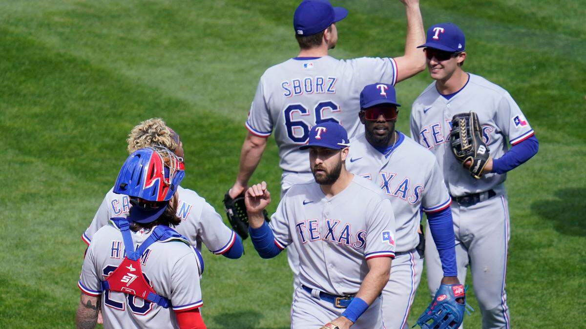 Texas Rangers’ Joey Gallo, center, goes through the celebration line after making a diving catch to end a 4-3 win in 10 innings over the Minnesota Twins at Target Field on Thursday.