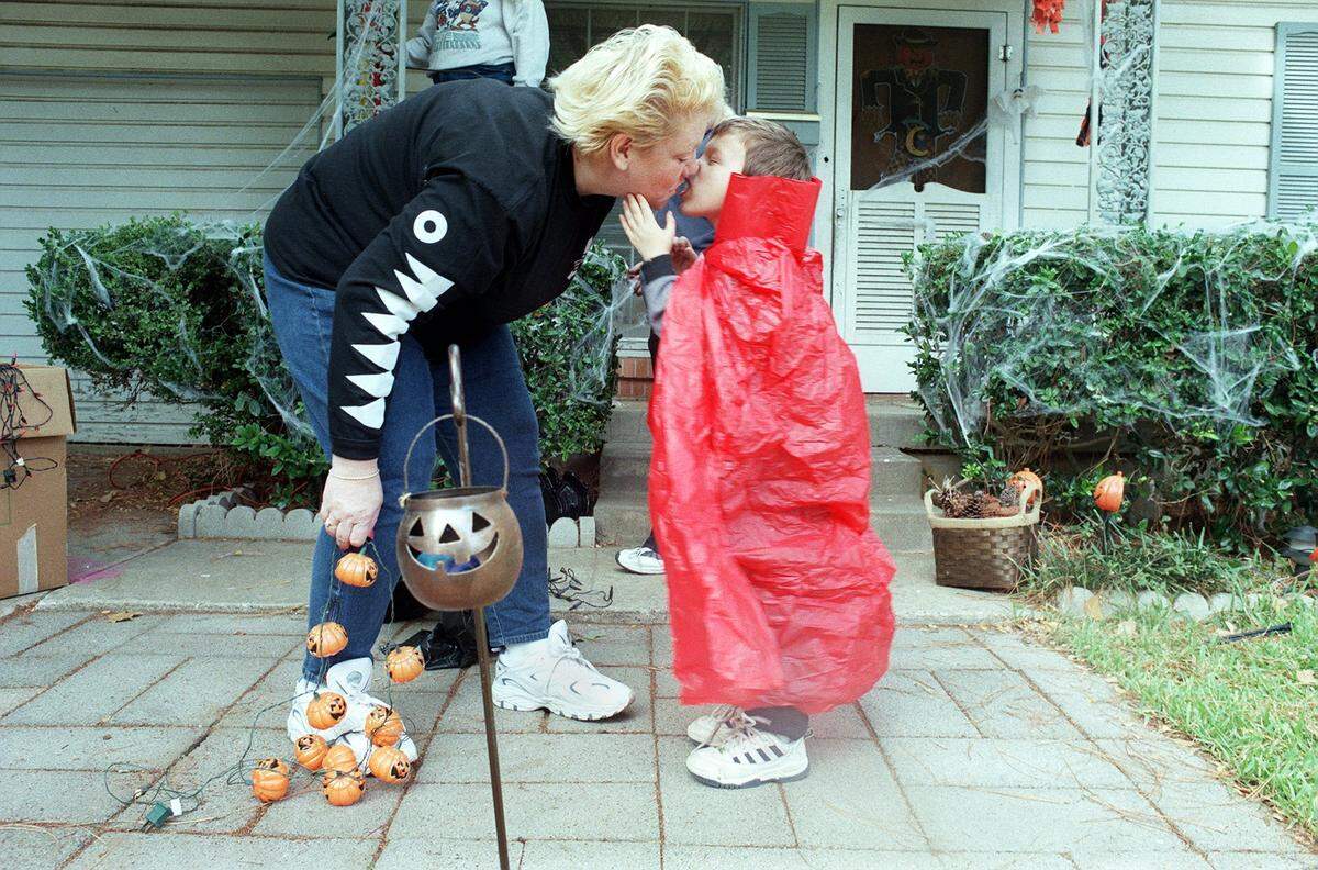 Oct. 8, 2000: Before going to the store for more Halloween decorations, Karen Benfante received a kiss from her son, Dylan, 4, who was dressed as Dracula. They helped decorate their Arlington residence Sunday afternoon.
