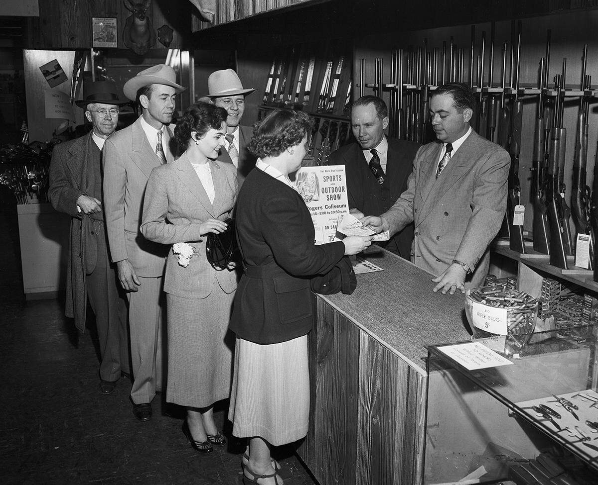 March 14, 1950: Advance sale of tickets for the Texas Sports and Outdoor Show brought early buyers in the sports department at Leonard Brothers department store. Making the sales are Bob Leonard, right, department manager, and Doc St. Clair. Purchasers are, left to right, J.C. Roberts, H.J. Rippetoe, H.E. Willett, Mary Graves and Mrs. Beatrice Hollis.