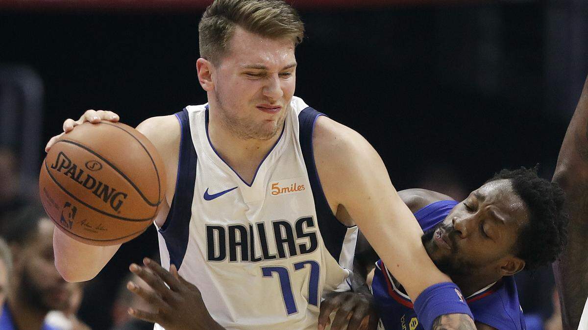 Dallas Mavericks’ Luka Doncic (77) is defended by Los Angeles Clippers’ Patrick Beverley during the first half of an NBA basketball game Thursday, Dec. 20, 2018, in Los Angeles. (AP Photo/Marcio Jose Sanchez)