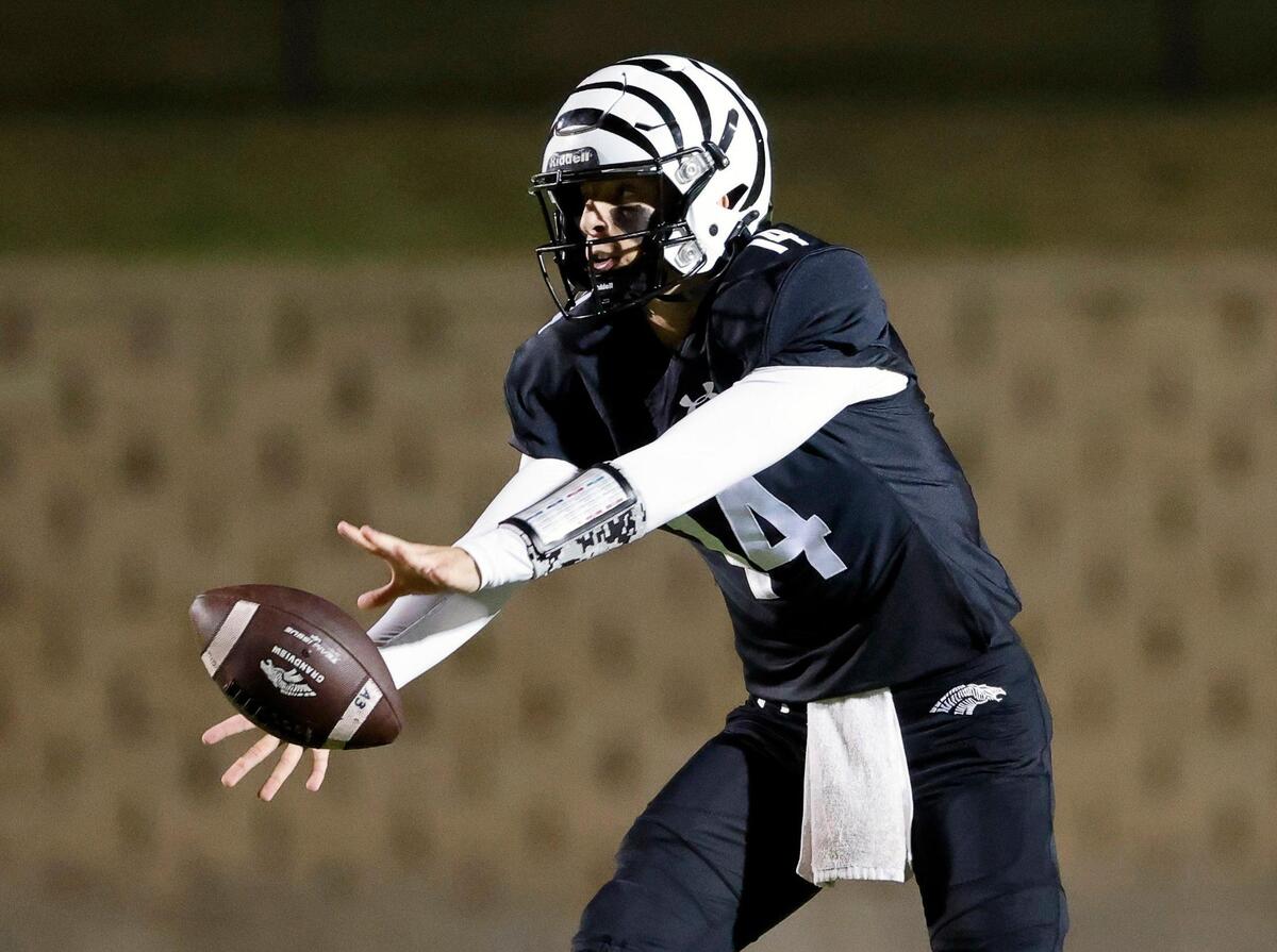 Grandview quarterback Ryder Hayes (14) takes the snap during a UIL Class 3A Division 1 area round playoff football game at Mesquite Memorial Stadium in Mesquite, Texas, Thursday, Nov. 16, 2023.