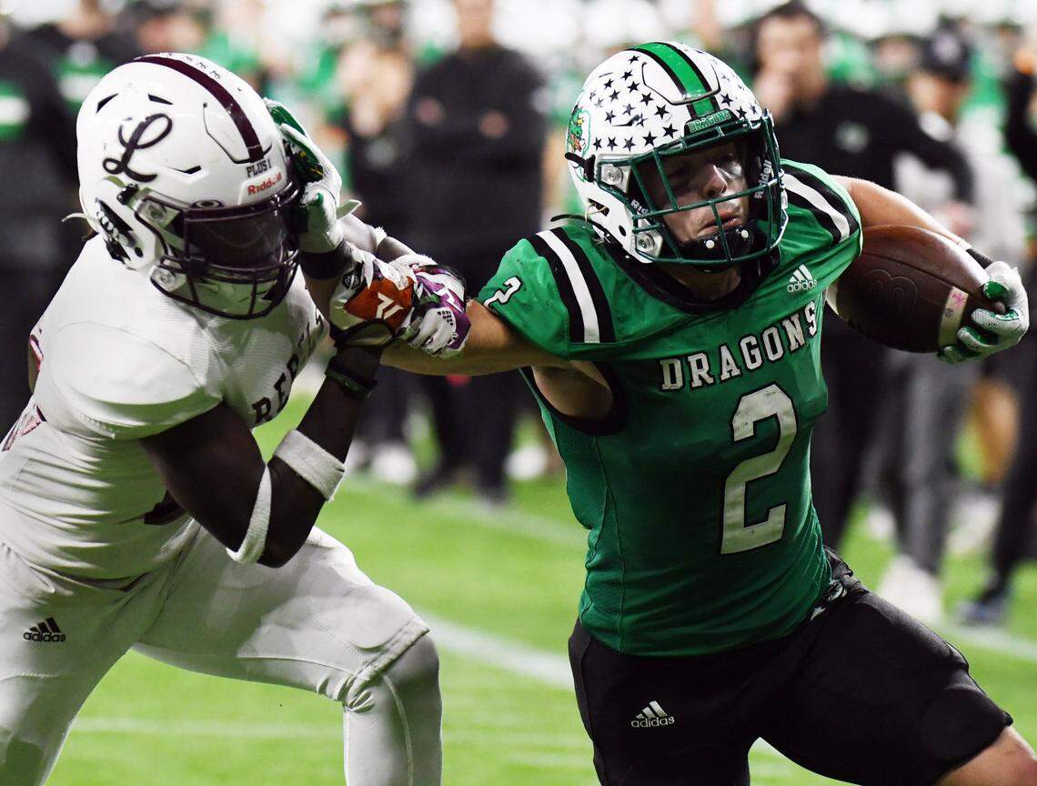 Midland Legacy’s Canyon Moses, left is stiff-armed by Southlake Carroll’s Owen Allen as he races up the field for a first down near the goal line in the fourth quarter of their Class 6A Division 1 Area football game Saturday, November 20, 2021 at Globe Life Field in Arlington, Texas. Carroll went on to win 42-7. Special/Bob Haynes