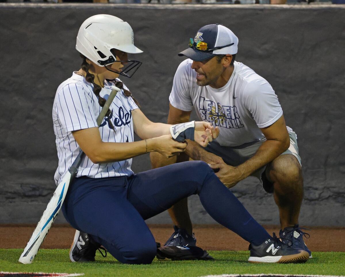 Keller head coach Chad Cribbs talks to catcher Kyla Fabela (14) before her at-bat during the Conference 6A Region 1 Regional Finals at Coppell Softball Field in Coppell, Texas, Saturday May 25, 2024.
