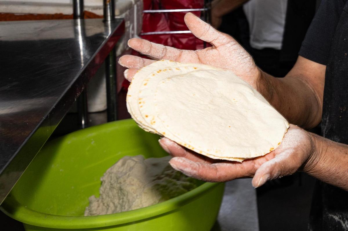 Margarita makes fresh tortillas in the kitchen at Birrieria y Taqueria Cortez in Fort Worth on Wednesday, Nov. 20, 2024. The restaurant earned a Michelin Recommended rating, landing the taqueria on a prestigious list of eateries around the nation.