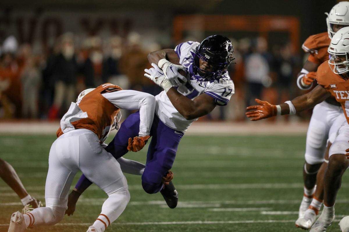TCU running back Trent Battle is tackled during their game against UT at the DKR Texas Memorial Stadium in Austin on Saturday, Nov. 12, 2022.