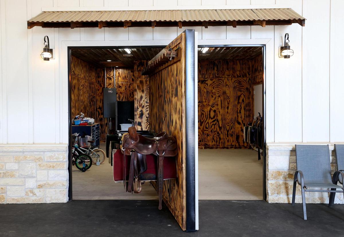 The tack room of the barn at 270 Price Lane in Weatherford has a door that swings open for access.