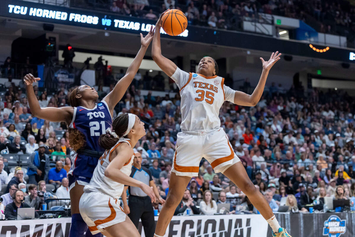 Texas Longhorns forward Madison Booker (35) rebounds the ball over TCU Horned Frogs guard Agnes Emma-Nnopu (21) during the second half of an Elite 8 NCAA Tournament basketball game at Legacy Arena.
