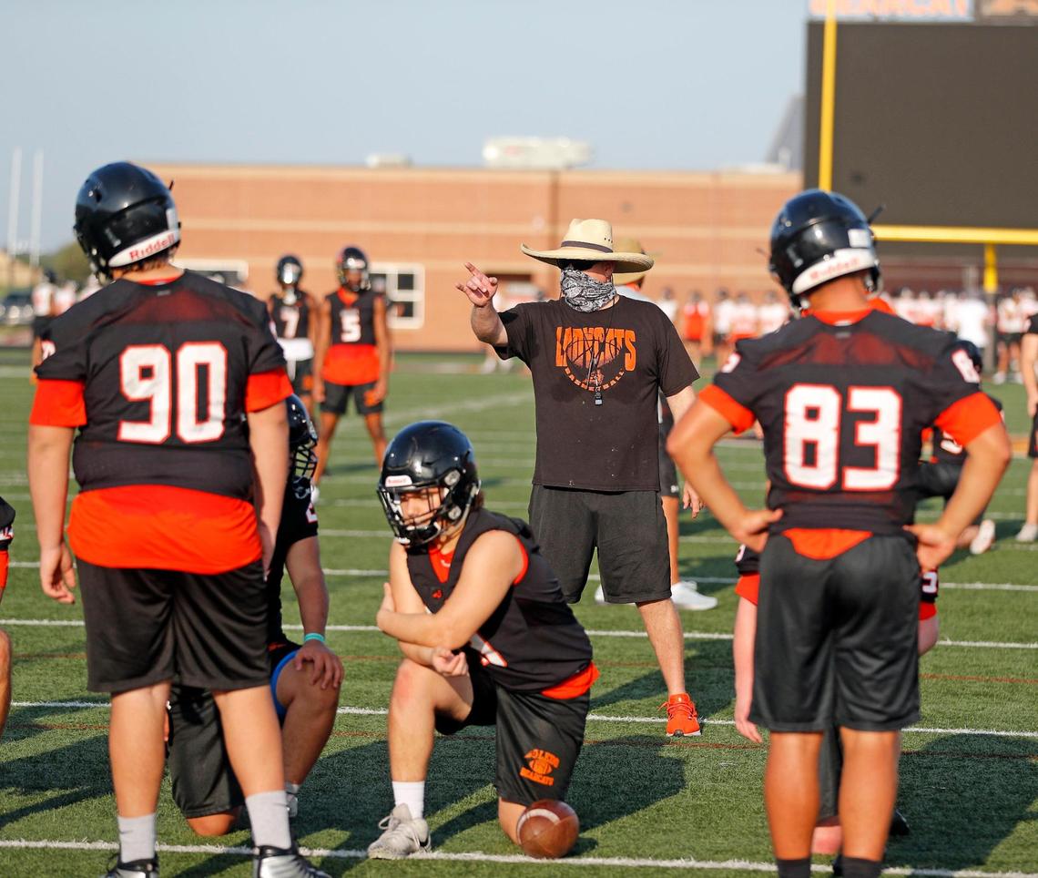 Aledo defensive backs coach Aaron Clark puts them through the paces during football practice at Bearcat Stadium in Aledo, Monday Sept. 07, 2020. The morning high for the first helmet practice was 75. (Special to the Star-Telegram Bob Booth)