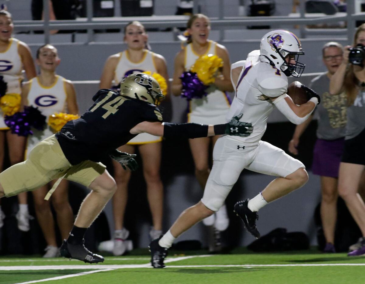 Grandbury’s Jackson Arnett escapes the grasp of Birdville’s Parker Green. Arnett scores on the play with 30 seconds left in the half Thursday night at Birdville Athletic Center. JOHN ROWLAND